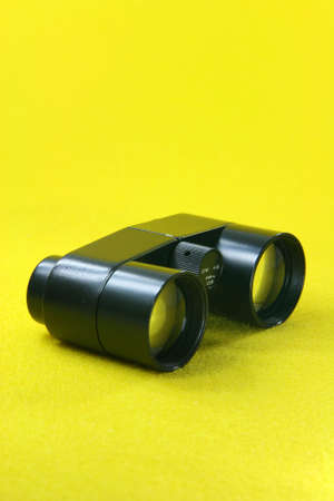 black retro binoculars from ussr in yellow background optic toolsの写真素材
