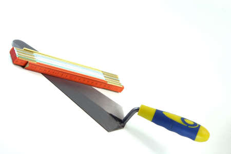construction tools trowel and meter isolated in white backgroundの写真素材