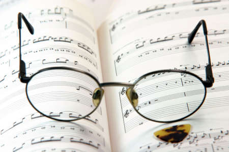 education concepts study music spectacles on a music book and guitar pickの写真素材