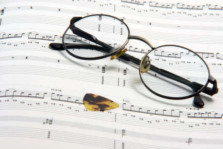 education concepts study music spectacles on a music book and guitar pickの写真素材
