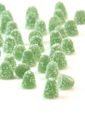 green sugar jelly mints isolated on white background sweets and candy with copy space verticalの写真素材