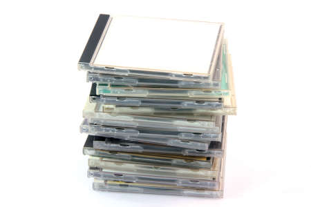 pile of cd cases isolated on white background and empty label to add your message