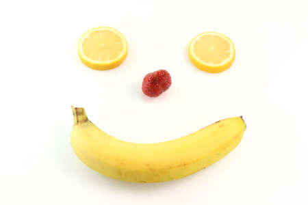 happy fruit face from banana mouth strawberry nose and eyes of lemon  humorous isolated on white backgroundの写真素材