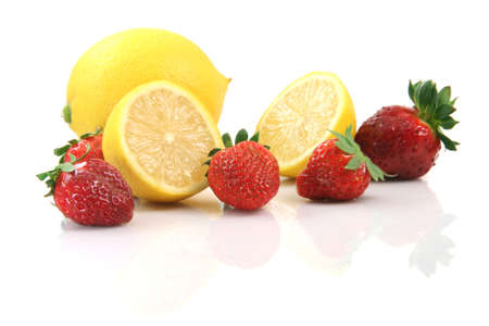 lemons and strawberries isolated on white background with reflection healthy eatingの写真素材