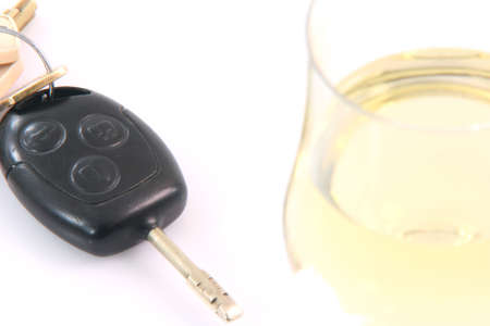 social issues don't drink and drive glass of wine close-up blurred and  car keys focus isolated on white backgroundの写真素材