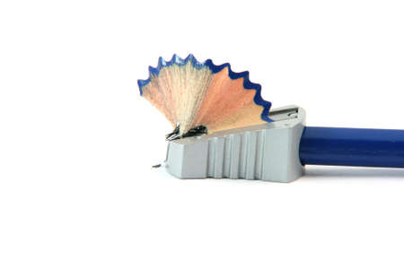 sharpening a pencil with  sharpener isolated on white backgroundの写真素材