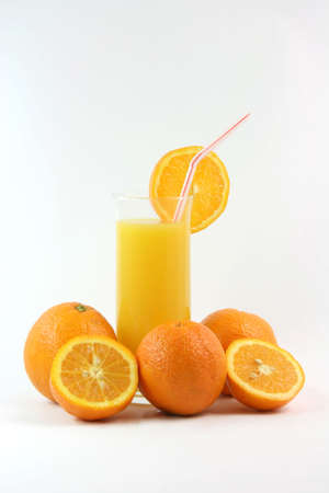 healthy eating glass of orange juice with straw and slice of orange and orangesの写真素材