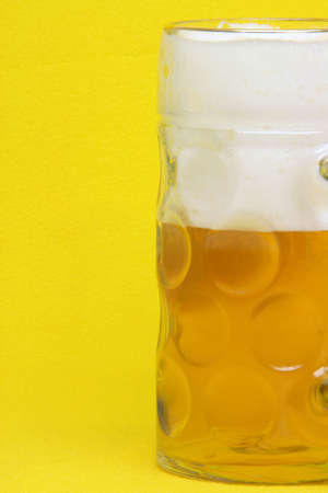 bavarian beer mug detail in yellow backgroundの写真素材