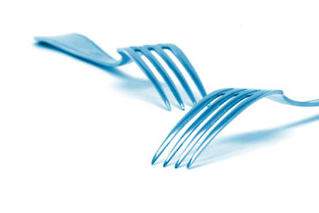two blue color forks isolated on white background food industry conceptsの写真素材