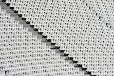 white seats tiers texture detail from stadium for background useの写真素材
