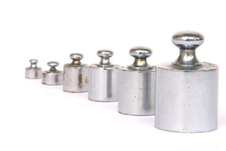 different weight units in a row focus on the big one isolated on white backgroundの写真素材