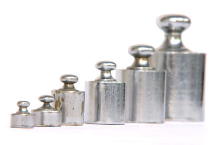 different weight units in a row focus on the small one isolated on white backgroundの写真素材