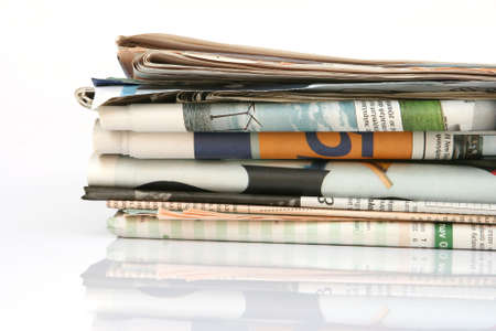 media concepts stack of newspapers with reflection isolated on white background