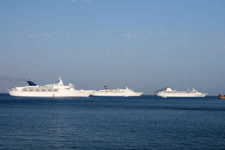 three cruise ships in deep blue at patmos island greeceの写真素材