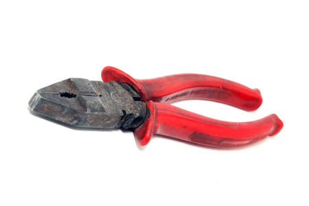 old used plier with red rubber handle isolatedの写真素材