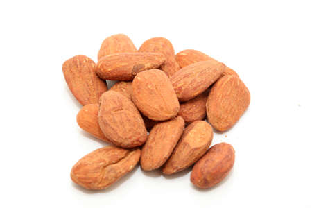 closeup almond nuts rasted and salted isolated on white backgroundの写真素材