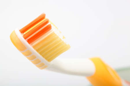 dental hygiene yellow  toobrush detail on white backgroundの写真素材