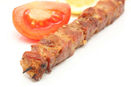 tomato lemon and  pork kebap on wooden stick  isolated の写真素材