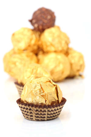 closeup gold wraped chocolate sphere dessertの写真素材