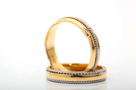 wedding bands closeup with reflection and copyspace on white backgroundの写真素材