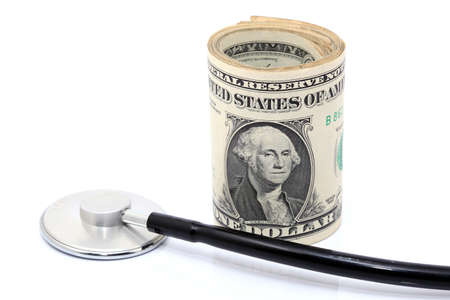 expensive health treatment stethoscope and dollars rolledの写真素材