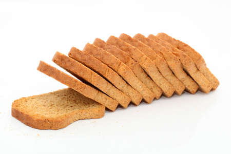 dry toasted bread loaf in slices isolated on white background