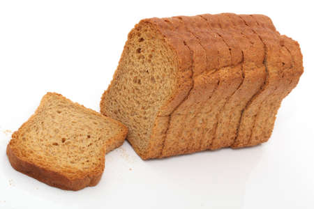 dry toasted bread loaf in slices isolated on white backgroundの写真素材