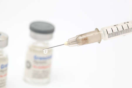 drug drop and syringe closeup detail on white backgroundの写真素材