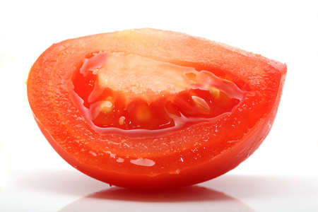 piece of juice tomato closeup isolated on white backgroundの写真素材