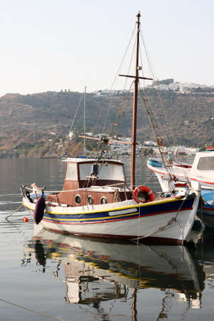boats and reflections with background skala and chora of patmos island greece dodecaneseの写真素材