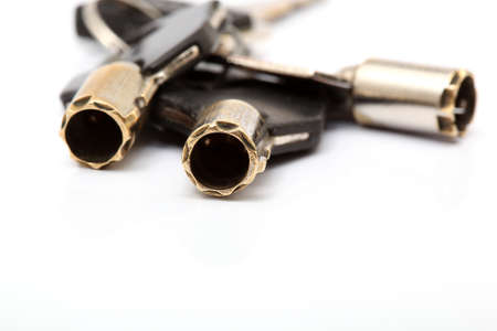 metallic security keys closeup detail with copyspace isolated on white の写真素材