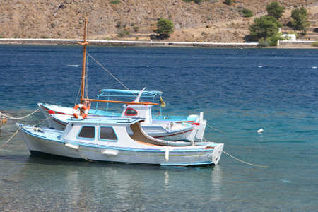 traditional greek fishing boats at harborの写真素材