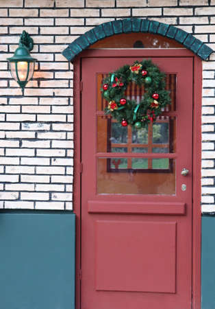door decorated for xmas with wreath for artificial house athens greeceの写真素材