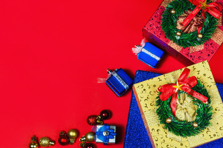 Merry colors gift boxes placed christmas on red backgroundの写真素材
