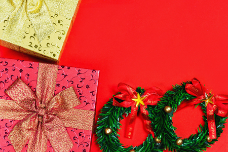 Merry colors gift boxes placed christmas on red backgroundの写真素材