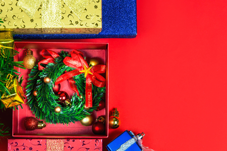 Merry colors gift boxes placed christmas on red backgroundの写真素材