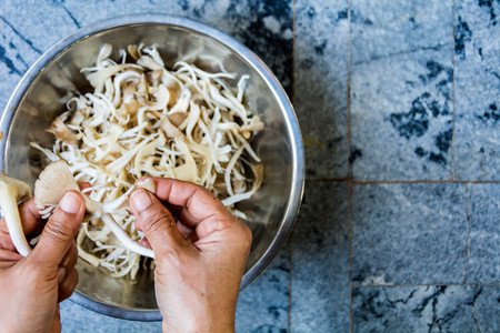 Preparing to cook the mushrooms in a bowlの写真素材