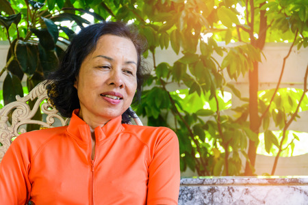 Middle-aged women sit leisurely at home during the dayの写真素材