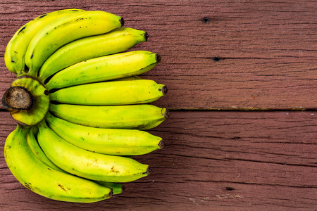 banana on old wood Red texture backgroundの写真素材