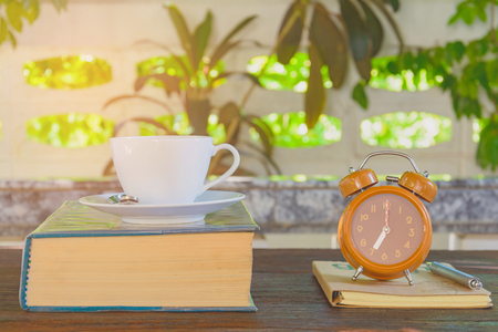 Coffee mug and book on old wooden table the good morningの写真素材