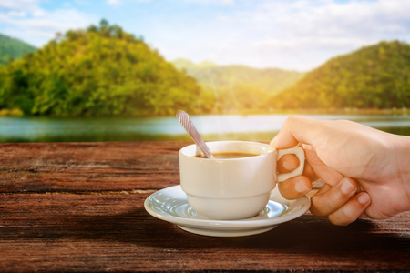 coffee cup on wood table and good morningの写真素材