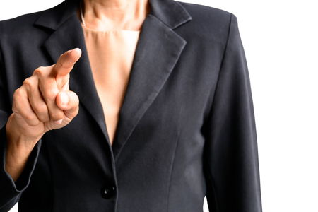 A lady wearing a black suit points her finger isolatedの写真素材