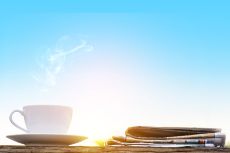 coffee cup clock and news paper on old wooden table nature background the good morningの写真素材