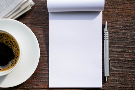 coffee cup clock and news paper on old wooden table nature background the good morningの写真素材