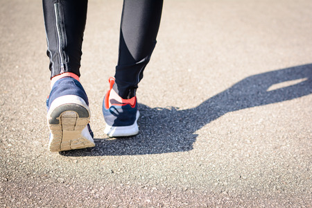 close up shoes Jogging on the street in the park at morning