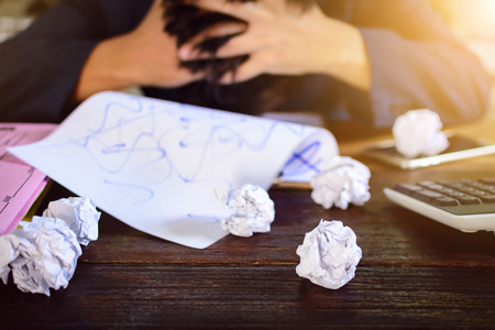 Businessmen stress and Fear Crushed paper on wood table . selective focusの写真素材