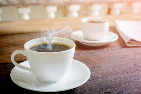 coffee cup clock and news paper on old wooden table nature background the good morningの写真素材
