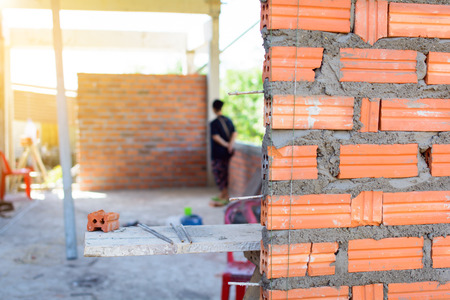 Construction wall Building with brick and cement at daytimeの写真素材
