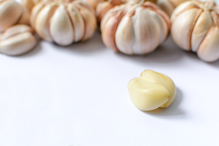 Garlic health food has a pungent odor on the white backgroundの写真素材