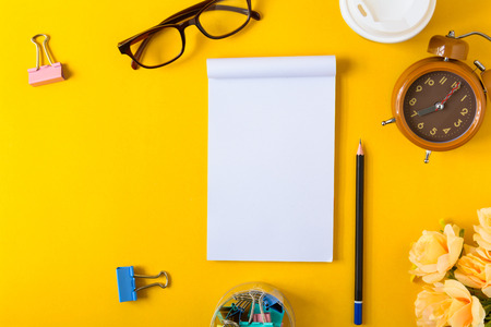 Office equipment on a yellow and golden paper desk with a business workspeac and color vivid